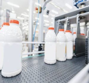 Milk bottles on a production line, illustrating real-time quality control with Process NIR in food manufacturing