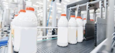Milk bottles on a production line, illustrating real-time quality control with Process NIR in food manufacturing