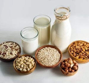 An assortment of alternative protein derived milks, including almond milk, soya milk and pea milk.