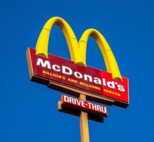 A McDonald's sign set against the backdrop of blue sky